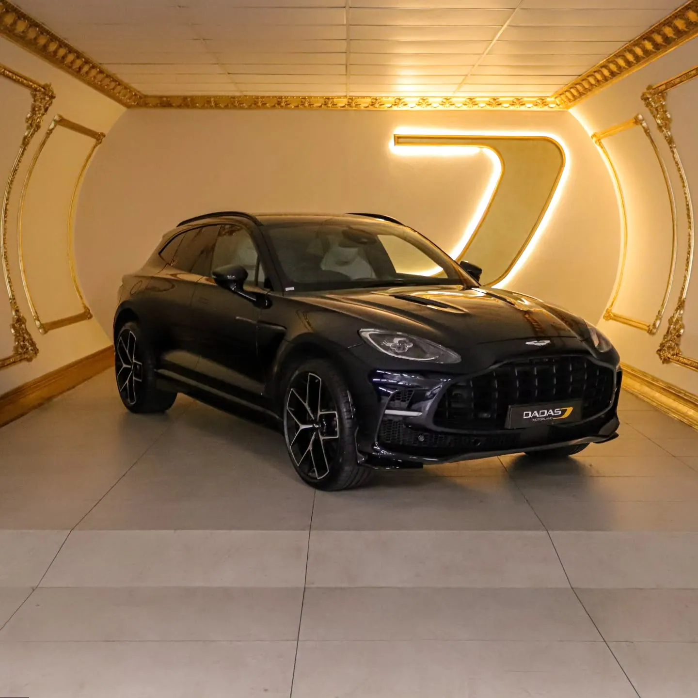 Luxury SUV under studio spotlights in the Dadas Motorland showroom